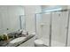Pristine bathroom showcasing a glass-enclosed shower, modern vanity with granite top, and neutral tones at 8940 Coconut Breeze Dr, Kissimmee, FL 34747
