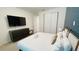 Cozy bedroom with a comfortable bed, stylish furnishings, and ample closet space for storage at 8940 Coconut Breeze Dr, Kissimmee, FL 34747