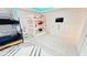Fun, spacious ' bedroom featuring a bunk bed, white dresser, and playful wallpaper and decor at 8940 Coconut Breeze Dr, Kissimmee, FL 34747