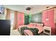 A bedroom with unique wall textures and patterns, including decorative lighting and pink accents at 8940 Coconut Breeze Dr, Kissimmee, FL 34747