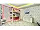 bedroom features a bunk bed, Mickey Mouse wallpaper, and a dresser with a television on top at 8940 Coconut Breeze Dr, Kissimmee, FL 34747