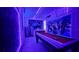 A futuristic game room illuminated with neon lights, pool table, and murals for entertainment at 8940 Coconut Breeze Dr, Kissimmee, FL 34747