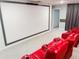 Well-appointed home theater with comfortable seating, a large screen, and customized lighting for a movie experience at 8940 Coconut Breeze Dr, Kissimmee, FL 34747