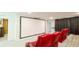 Luxurious home theater featuring reclining chairs, a huge projection screen, and tiered platform seating at 8940 Coconut Breeze Dr, Kissimmee, FL 34747