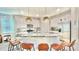 Bright kitchen boasts stainless steel appliances, granite countertops, an island and a breakfast bar at 8940 Coconut Breeze Dr, Kissimmee, FL 34747