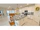 Bright, open-concept kitchen with an island, bar stools, and seamless flow into the living area at 8940 Coconut Breeze Dr, Kissimmee, FL 34747