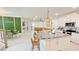 Open concept kitchen with granite countertops, stainless steel appliances and a large island with barstool seating at 8940 Coconut Breeze Dr, Kissimmee, FL 34747