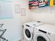 Well-lit laundry room features a front-load washer and dryer set, organized shelving, and natural light at 8940 Coconut Breeze Dr, Kissimmee, FL 34747