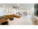 Bright, open-concept living room showcasing a modern kitchen with stainless steel appliances and sleek countertops at 8940 Coconut Breeze Dr, Kissimmee, FL 34747