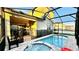 This home boasts a beautiful screened-in pool and jacuzzi with brick pavers, perfect for relaxing and enjoying the Florida sunshine at 8940 Coconut Breeze Dr, Kissimmee, FL 34747