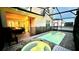 The screened-in pool and jacuzzi are surrounded by brick pavers and are perfect for a relaxing evening under the stars at 8940 Coconut Breeze Dr, Kissimmee, FL 34747