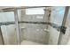 This shower has glass doors, a shower head, a window and a built-in soap shelf at 8940 Coconut Breeze Dr, Kissimmee, FL 34747
