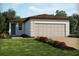 Charming single story home with a manicured lawn, neutral color palette, and a two car garage at 907 Donahue Pass, Lake Hamilton, FL 33851