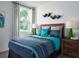 Bright bedroom with a playful accent wall, patterned curtains, and ample natural light at 909 Donahue Pass, Lake Hamilton, FL 33851