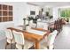 Open-concept kitchen flows into dining area; featuring white cabinets, stainless appliances, and island seating at 909 Donahue Pass, Lake Hamilton, FL 33851