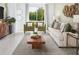 Comfortable living room with large windows, stylish decor, a modern rug, and a cozy seating arrangement at 909 Donahue Pass, Lake Hamilton, FL 33851