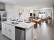 Open-concept kitchen with island seating flows into a dining area and living room, great for entertaining at 911 Donahue Pass, Lake Hamilton, FL 33851