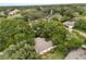 Aerial view of home nestled amongst mature trees in a lush residential neighborhood near a golf course at 926 Ridgeland Ct, Apopka, FL 32712