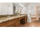 Bathroom featuring a dual sink vanity with granite countertops, a soaking tub, and a separate shower at 926 Ridgeland Ct, Apopka, FL 32712