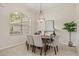 Stylish dining room with an oval table, six chairs, and elegant chandelier at 926 Ridgeland Ct, Apopka, FL 32712