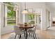 Bright dining area with a round table, modern chairs, and sliding glass doors to the patio at 926 Ridgeland Ct, Apopka, FL 32712