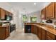 Well-lit kitchen with wood cabinets, granite countertops, and a view into the dining area at 926 Ridgeland Ct, Apopka, FL 32712