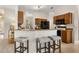Inviting kitchen with breakfast bar seating, warm wood cabinets, and modern appliances for easy meal prep at 926 Ridgeland Ct, Apopka, FL 32712