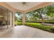 The covered patio boasts beautiful lush landscaping and views of the backyard at 926 Ridgeland Ct, Apopka, FL 32712