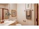 Cozy bathroom featuring a modern sink, framed art, and a glass-enclosed shower at 11003 Hollow Bay Dr, Winter Garden, FL 34787