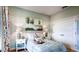 Charming bedroom with a large painting, two side tables, and a comfortable bed that create an inviting space at 11003 Hollow Bay Dr, Winter Garden, FL 34787