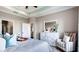 Serene bedroom featuring a dresser, decorative mirror, and chair, creating a peaceful retreat for relaxation and rest at 11003 Hollow Bay Dr, Winter Garden, FL 34787