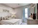 Beautiful bedroom with large window, stylish curtains, and a decorative headboard at 11003 Hollow Bay Dr, Winter Garden, FL 34787
