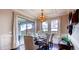 Bright dining area with hardwood floors, stylish light fixture, and sliding glass doors leading to an outdoor patio at 11003 Hollow Bay Dr, Winter Garden, FL 34787
