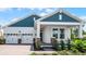 Charming single-Gathering home boasting a two-car garage, welcoming front porch, and nicely manicured front yard landscaping at 11003 Hollow Bay Dr, Winter Garden, FL 34787
