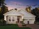 Charming single-story home featuring craftsman-style architecture and a two-car garage in a lush, tropical landscape at 11003 Hollow Bay Dr, Winter Garden, FL 34787
