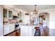 Elegant kitchen featuring stainless steel appliances, a center island with bar seating, and hardwood flooring at 11003 Hollow Bay Dr, Winter Garden, FL 34787