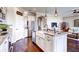 A modern kitchen features a large island with sink, stainless steel appliances, and open layout flowing into the living area at 11003 Hollow Bay Dr, Winter Garden, FL 34787