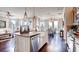 Bright, open-concept kitchen with an island and stainless steel appliances, connects seamlessly to a dining area with natural light at 11003 Hollow Bay Dr, Winter Garden, FL 34787