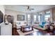 Comfortable living room featuring neutral tones, hardwood floors, and large windows offering plenty of natural light at 11003 Hollow Bay Dr, Winter Garden, FL 34787