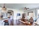Open concept living room with dark hardwood floors, comfortable furniture, and seamless transition to dining and kitchen at 11003 Hollow Bay Dr, Winter Garden, FL 34787