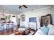Inviting living room featuring hardwood floors, white sofas, and a modern television setup, with a view to kitchen at 11003 Hollow Bay Dr, Winter Garden, FL 34787