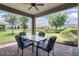 Covered patio area with a table and chairs overlooking a well-maintained lawn at 11003 Hollow Bay Dr, Winter Garden, FL 34787