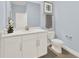 Powder room with modern white vanity, grey walls, and stylish fixtures at 11057 Hollow Bay Dr, Winter Garden, FL 34787