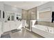 Light and bright bathroom featuring a soaker tub, walk-in shower, and double sink vanity at 11057 Hollow Bay Dr, Winter Garden, FL 34787