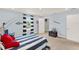 Nautical themed bedroom with striped bedding, white paneling, and light carpet at 11057 Hollow Bay Dr, Winter Garden, FL 34787