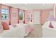 A charming bedroom with pink walls features natural light and cozy decor at 11057 Hollow Bay Dr, Winter Garden, FL 34787