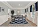 Dining room featuring wood floors, modern decor, and large windows with decorative curtains at 11057 Hollow Bay Dr, Winter Garden, FL 34787