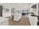 Modern open-concept kitchen with white cabinetry, an island, and wood flooring at 11057 Hollow Bay Dr, Winter Garden, FL 34787