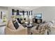 Living room features modern decor, neutral colors, wood floors, and large windows at 11057 Hollow Bay Dr, Winter Garden, FL 34787