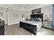 Beautiful main bedroom with tray ceiling, wood flooring, and an ensuite bathroom at 11057 Hollow Bay Dr, Winter Garden, FL 34787